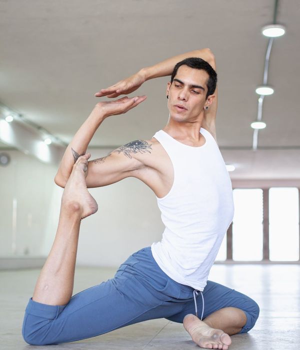 Man performing a controlled strength exercise in a minimalist setting.