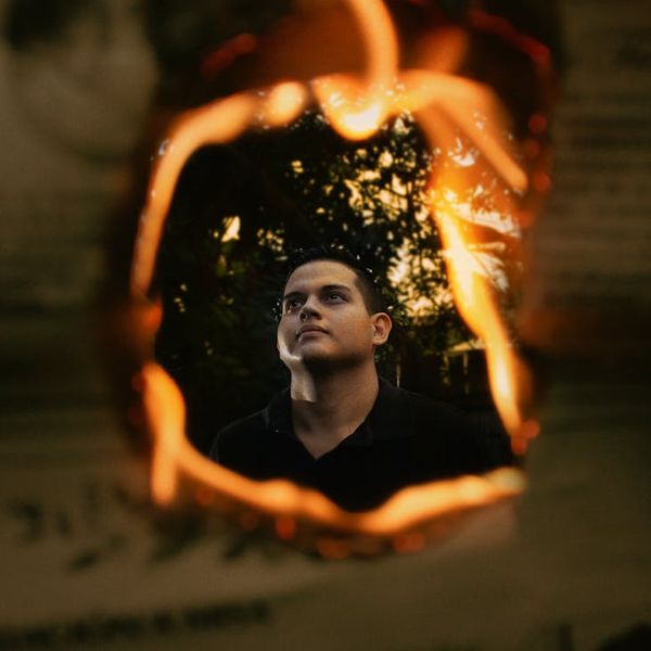 Silhouette of a man stretching against a sunrise, symbolizing new energy.